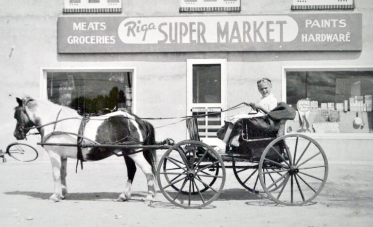 Arvīds Jūrmalietis’ store “Riga Supermarket” in Petawawa, Canada, around 1956–1957. Arvīds’ daughter Silvija is sitting in a horse-drawn carriage in front of the store. From the collection of the Museum “Latvians Abroad” LPplgD2023.197.
