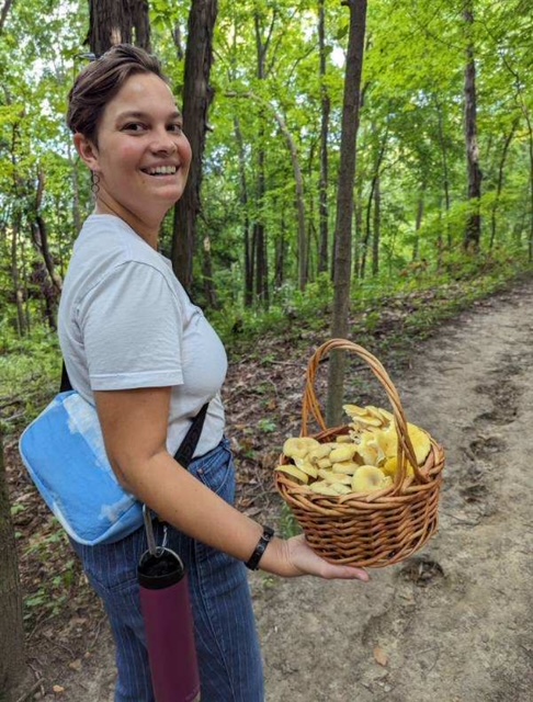 Larisa with golden oyster mushrooms (Pleurotus citrinopileatus). Ann Arbor, Michigan.