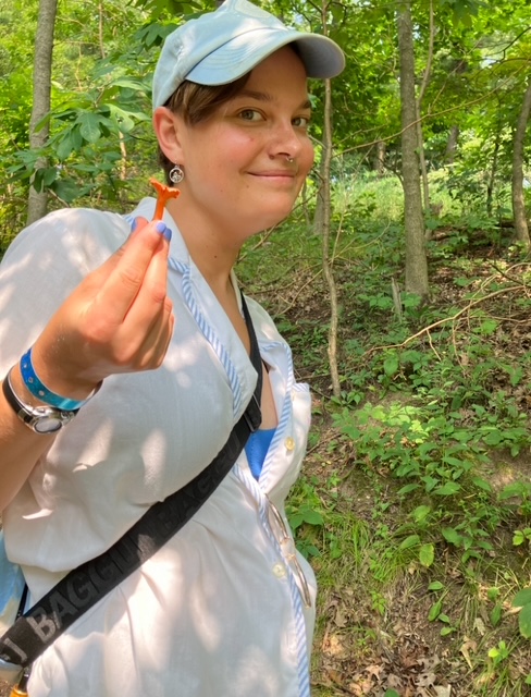 Larisa with a small red chanterelle (Cantharellus cinnabarinus). Garezers, Michigan.