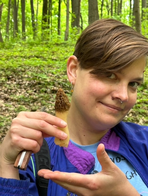 Larisa with a morel (Morchella esculenta). Ann Arbor, Michigan.